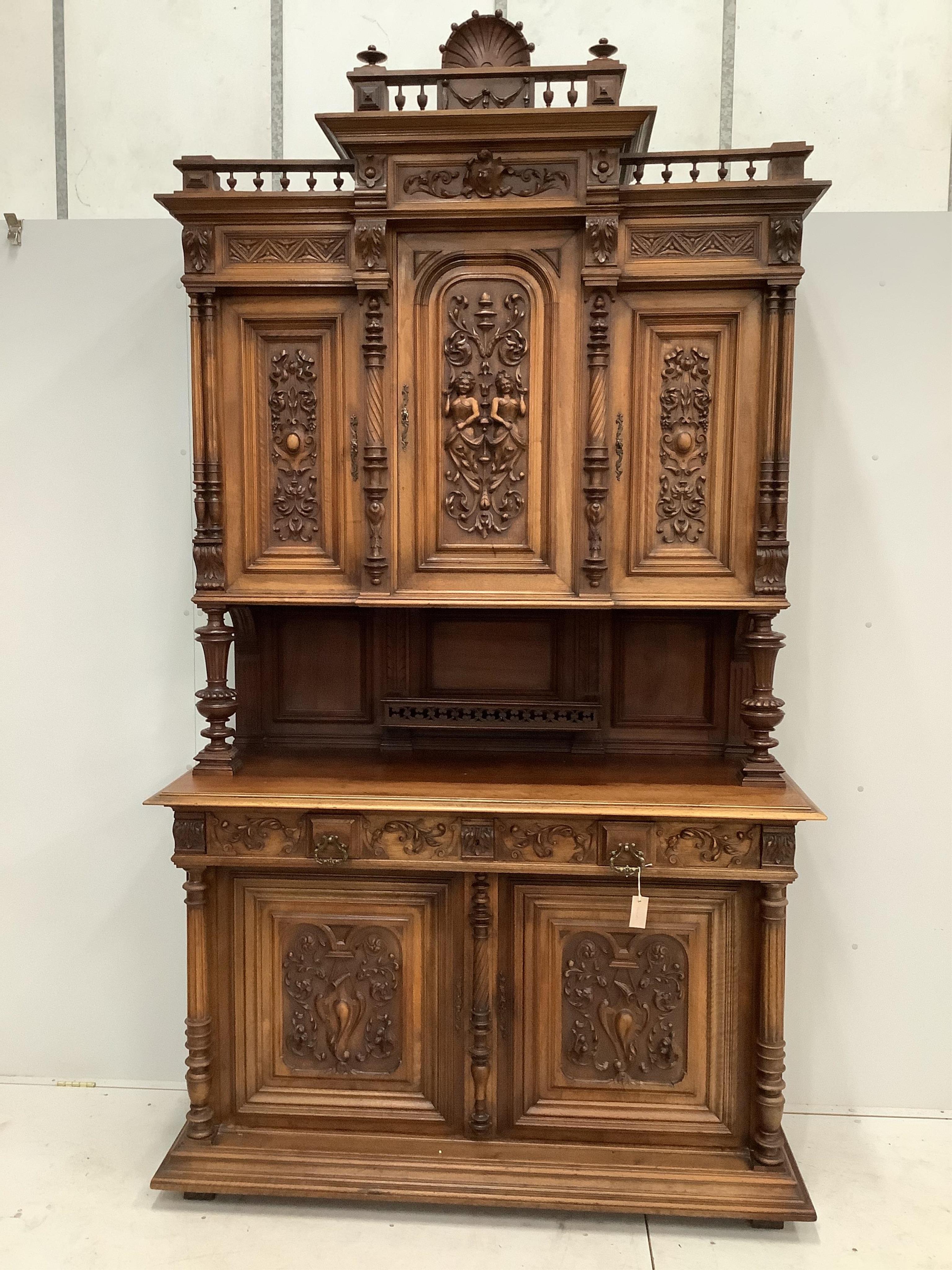 A late 19th century Continental carved walnut buffet, width 150cm, depth 58cm, height 270cm. Condition - good